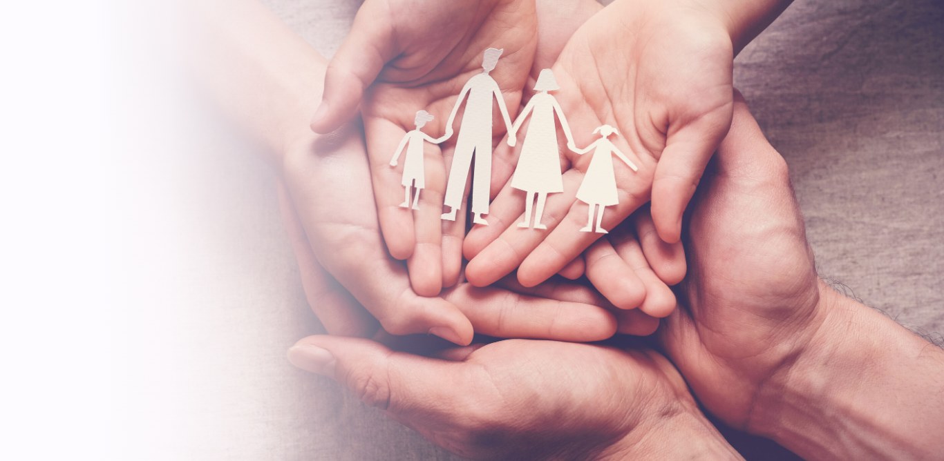 Family lawyers Dubbo – hands holding a paper cut-out family